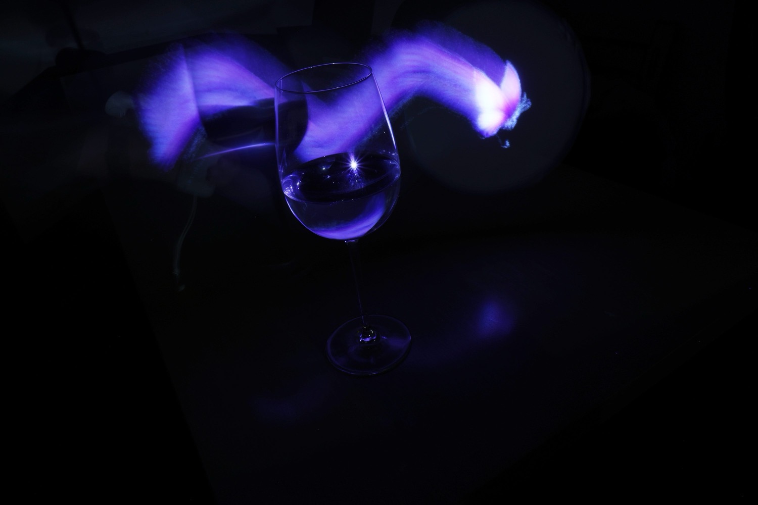 Butterfly stamp placed in live mode behind a wine glass